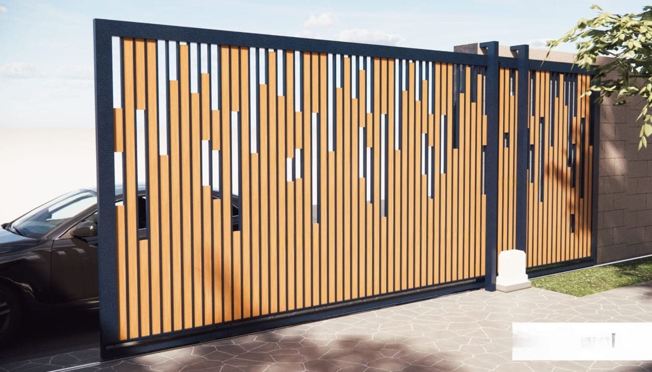 An automated sliding gate standing open at the entrance to a compound
